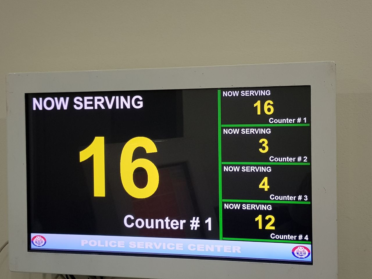 xQue now-serving counter display screen at a Police Service Center
